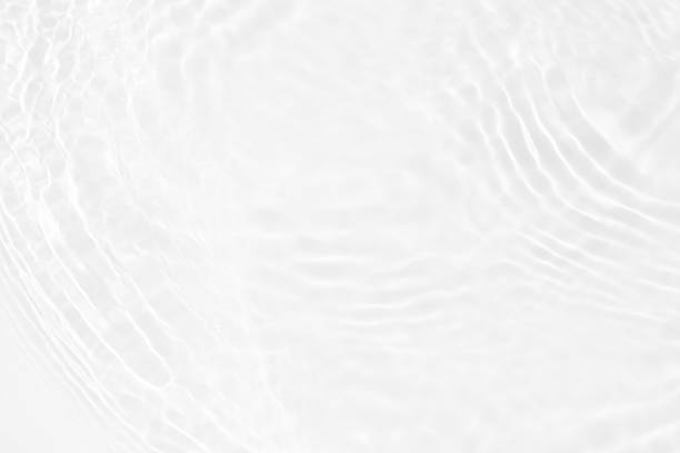 istock White water with ripples on the surface. Defocus blurred transparent white colored clear calm water surface texture with splashes and bubbles. Water waves with shining pattern texture background. 2215839467