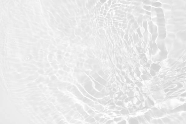 istock White water with ripples on the surface. Defocus blurred transparent white colored clear calm water surface texture with splashes and bubbles. Water waves with shining pattern texture background. 2215839495