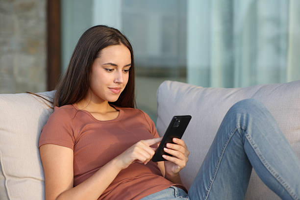 istock Woman in a terrace or balcony using phone 2215841607