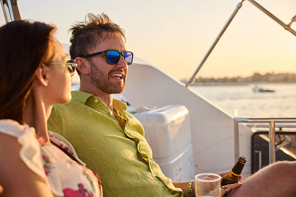 istock Man talking with girlfriend while sitting in yacht 2215841643