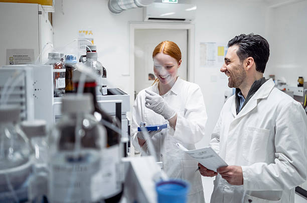 istock Young Female and Male Pharmacy Workers Collaborating in Brightly Lit Laboratory Environment 2215842292