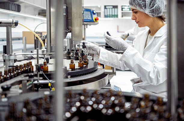 istock Mid Adult Female Lab Worker Packaging Products in Modern Laboratory Environment 2215843103