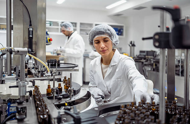 istock Mid Adult Caucasian Female Lab Worker Sorting Products in Bright Sterile Laboratory 2215843124