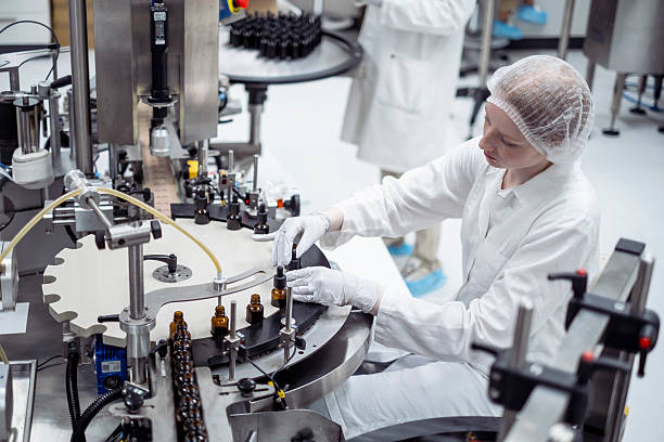 istock Focused Female Lab Worker in White Attire Packaging Products in a Modern Industrial Setting 2215843147