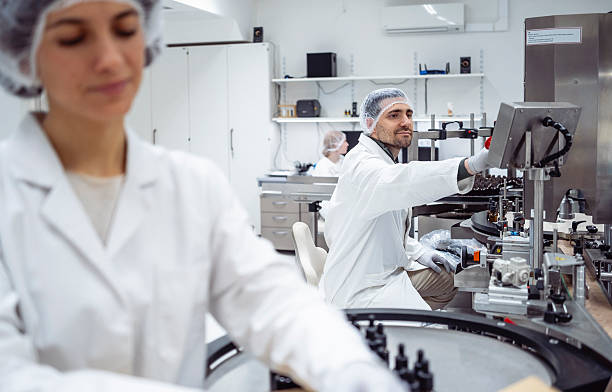 istock Mid Adult Laboratory Technician Operating Automated Equipment In Modern Pharmaceutical Facility 2215843172