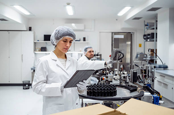 istock Mid Adult Female Lab Worker in Sterile Laboratory Using Tablet under Bright Artificial Lighting 2215843174