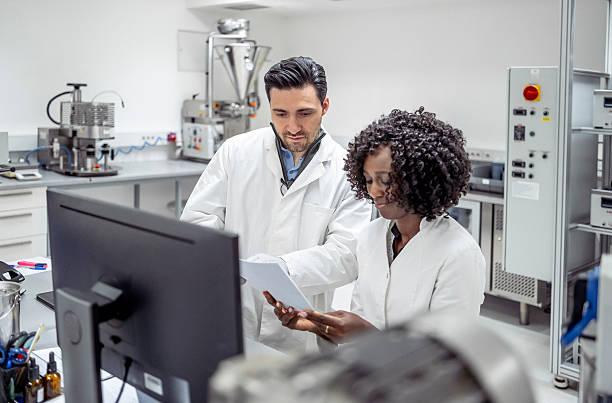 istock Diverse Male and Female Pharmacy Workers in Lab Coats Collaborating in Modern Laboratory Setting 2215843197