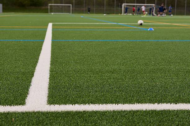 istock Close-up of a soccer field with white lines. 2215843258