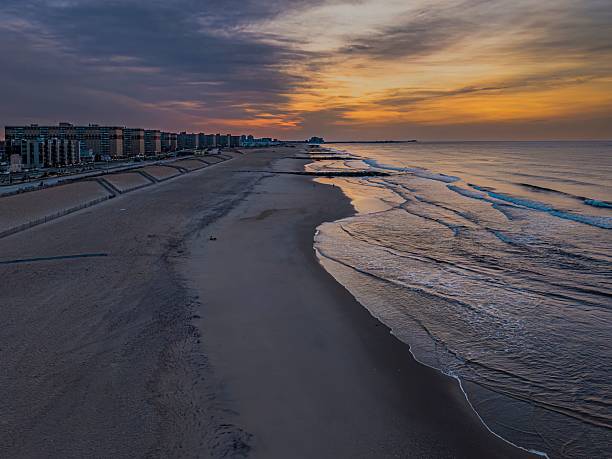 istock Aerial beach sunset with cityscape view. 2215843844