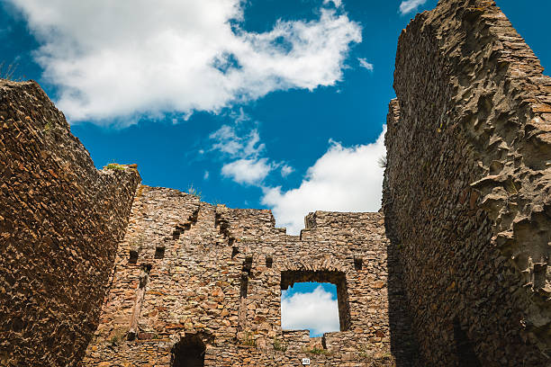 Part of ruins of the stone defensive tower of Hubkiv Castle of the 15th century, Ukraine, bottom up view against the cloudy sky in rainy day