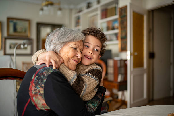 Grandchild embracing grandmother, sharing a tender moment of love and affection in the cozy atmosphere of their home