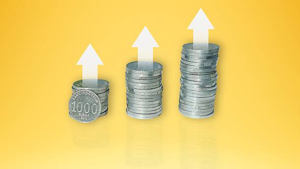 istock Stack of silver coins on yellow background. Business and finance concept 2215846149