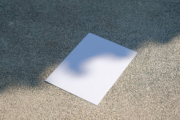 istock empty vertical paper poster mockup on concrete stone floor or pavement outdoors, shadow overlay 2215846151