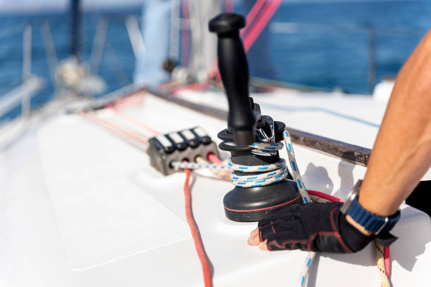 istock Sailor adjusting winch on a sailing yacht 2215846733