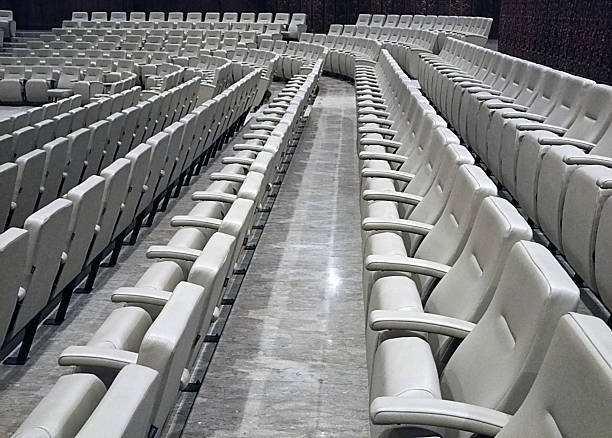 istock An empty auditorium with rows of beige seats 2215847662
