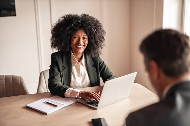 istock Smiling Businesswoman Using Laptop During Office Meeting 2215848544