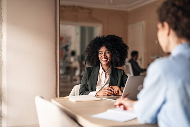istock Professional Woman Engaged in Business Discussion in Modern Office Setting 2215848743