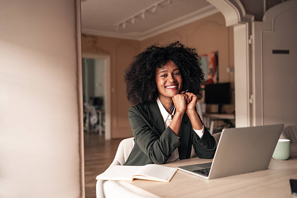 istock Confident Young Professional Smiling While Working on a Laptop at Desk 2215849392