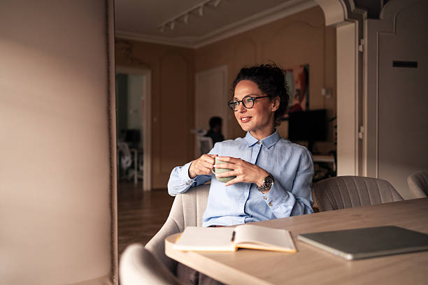 istock Smiling Professional Enjoying Relaxing Moment with a Warm Drink in Office 2215849398