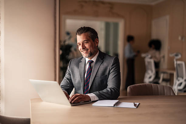 istock Confident Businessman Working on Laptop in Well-Lit Office Space 2215849886