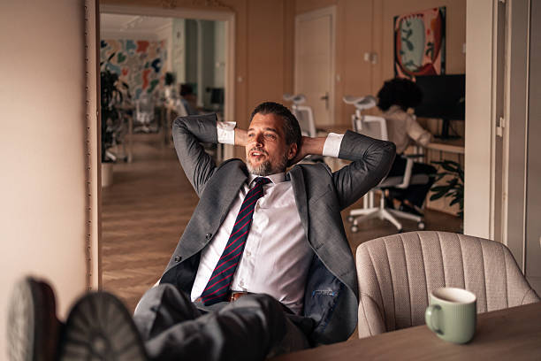 istock Confident Businessman Relaxing in a Modern Office Environment 2215849959