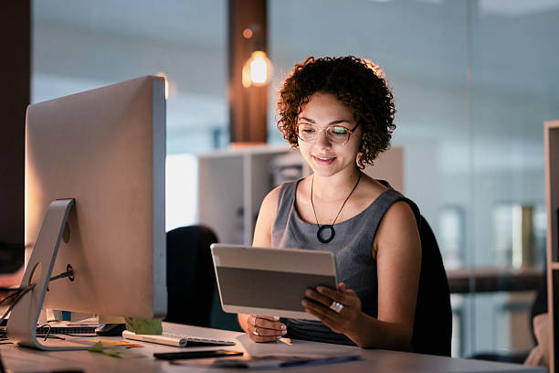 istock Confident Professional Woman Using a Digital Tablet at Her Workplace in a Modern Office Setting 2215851461