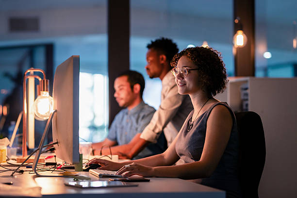 Team of Professionals Collaborating Late at Night in a Modern Office