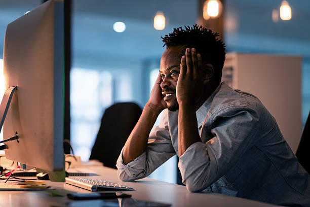 istock Man Focusing on Computer Work Late at Night in an Office Environment 2215851474