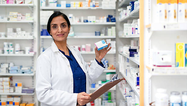 istock Friendly Female Pharmacist Holding Medication in a Pharmacy Setting 2215852183