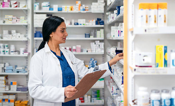 istock Professional Pharmacist Organizing Medication Inventory in a Well-Stocked Pharmacy 2215852189