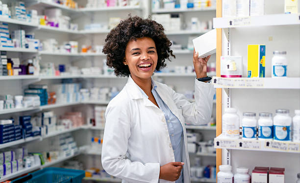 istock Friendly Pharmacist Assisting Customers in a Well-Organized Pharmacy 2215852192