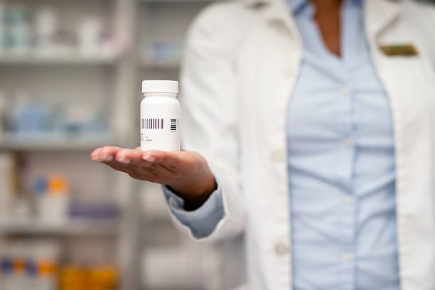 istock Professional Pharmacist Presenting a Medicine Bottle in Healthcare Setting 2215852199