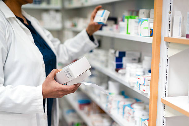 istock A Pharmacist Organizing Medication Boxes on Pharmacy Shelves in a Professional Environment 2215852205