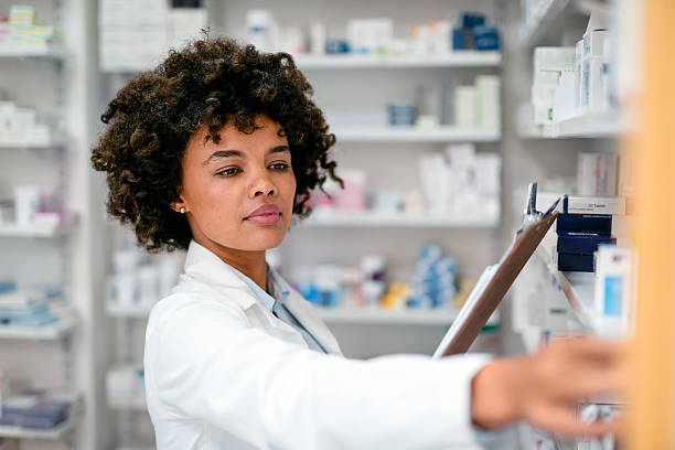 istock Confident Pharmacist Organizing Inventory in a Well-Stocked Modern Pharmacy 2215852219