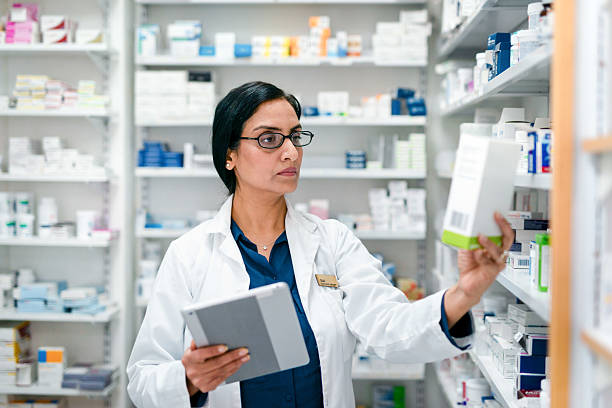 istock Professional Pharmacist Organizing Medications in a Well-Equipped Pharmacy Environment 2215852233