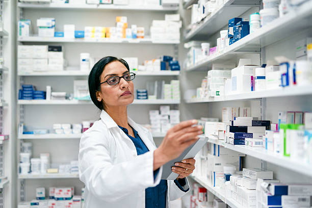istock Experienced Pharmacist Organizing Shelves in a Modern Pharmacy Setting 2215852235