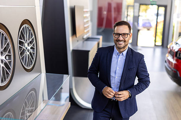 istock Car salesman showing customer rim sizes when buying car 2215852251