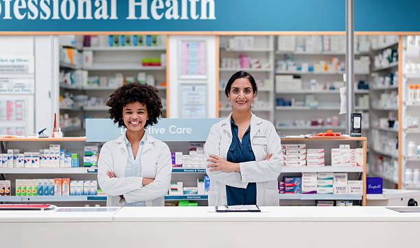 istock Two Confident Female Pharmacists in a Modern Pharmacy Setting, Smiling While Standing at the Counter 2215853151