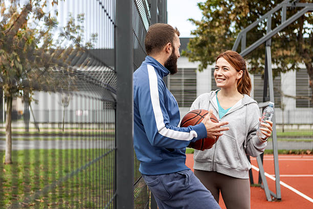 istock Couple Enjoying a Break Outdoors from Their Basketball Match 2215853162