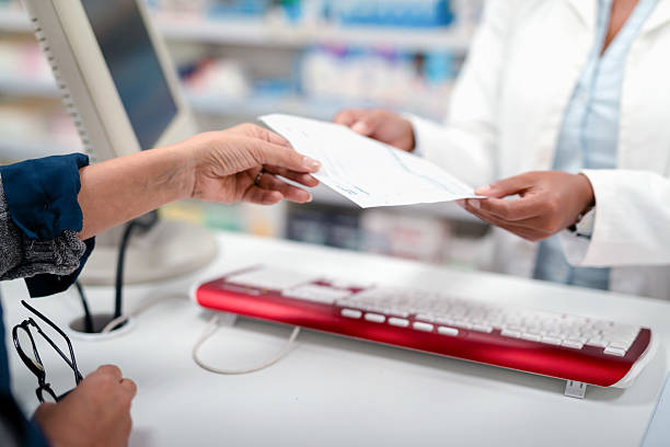 istock Customer Receives a Prescription from a Pharmacist in a Modern Pharmacy Setting 2215853194