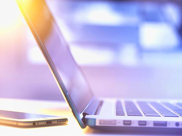 istock A close-up shot displays a laptop and smartphone, hinting at modern tech and communication. 2215855170