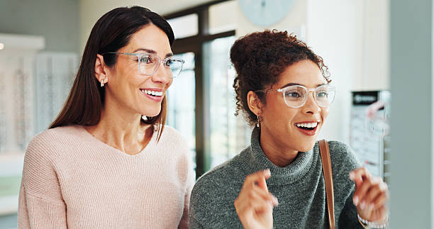 Optometry, women and client with glasses, happy and friendly service with clear vision. Help, customer or professional in store, trust or advice for designer frame decision, eyewear or consultation