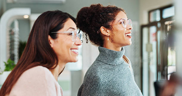 istock Optometry, women and client with glasses, consultation and friendly service with clear vision. Help, customer and professional in store, lenses and advice for designer frame, smile and eyewear 2215855673