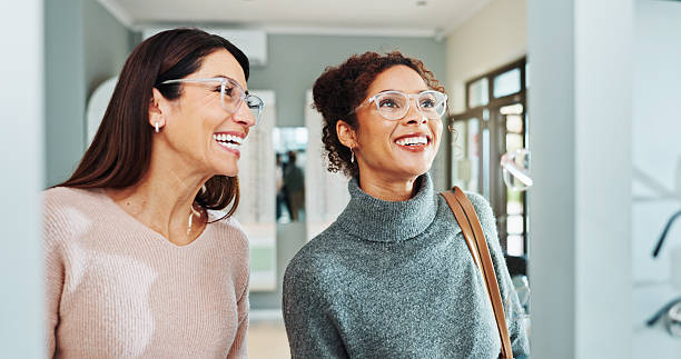 istock Optometry, women and client with glasses, smile and friendly service with consultation. Help, customer and professional in store, trust and advice for designer frame decision, eyewear or clear vision 2215855681