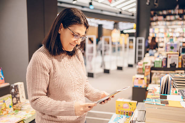 istock Woman shopping in a bookstore 2215856358