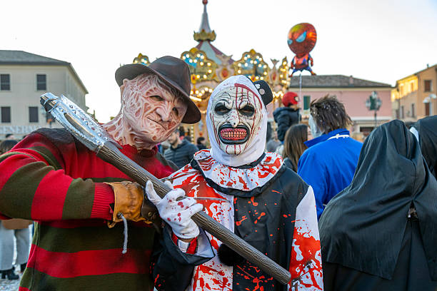 Piove di Sacco, Padua, Italy - Mar 16th, 2025: Carnival in Italy with people in scary horror costumes, featuring Freddy Krueger and killer clown