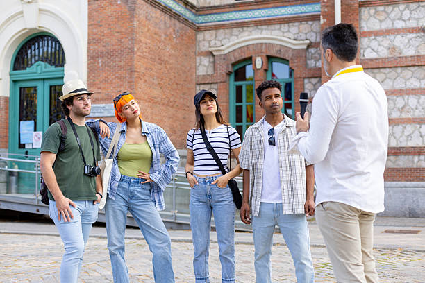 istock Tour guide explaining to tourists visiting a museum or historical building 2215856440