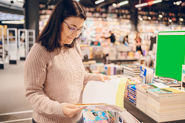 istock Woman shopping in a bookstore 2215856507