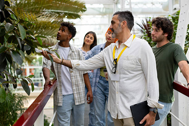 Professor explaining botany to students during greenhouse visit