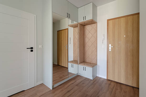 istock Modern Apartment Entryway with Mirrored Wardrobe and Upholstered Bench 2215857005